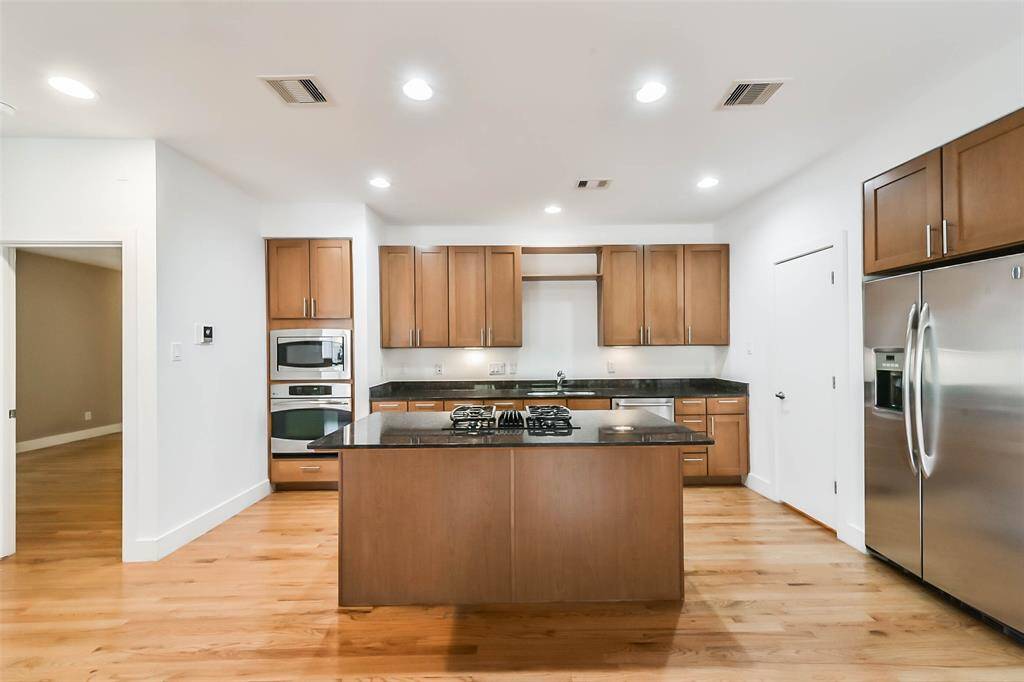 Additional kitchen view with chef's island and dine-in/buffet bar.