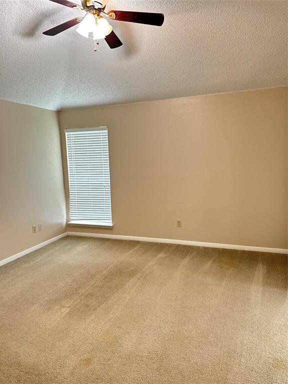 Bedroom 1 with ceiling fan and high ceilings