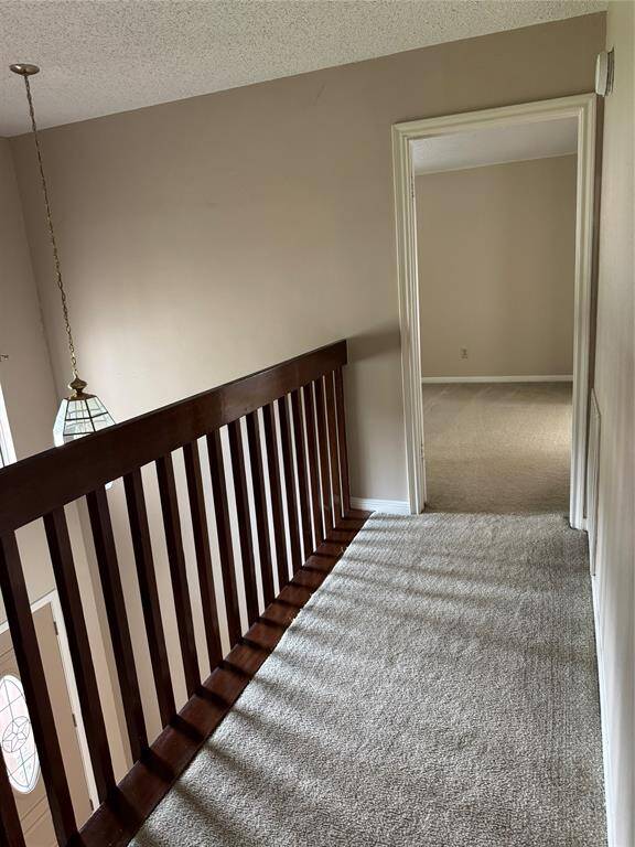 Hallway upstairs leading to primary bedroom
