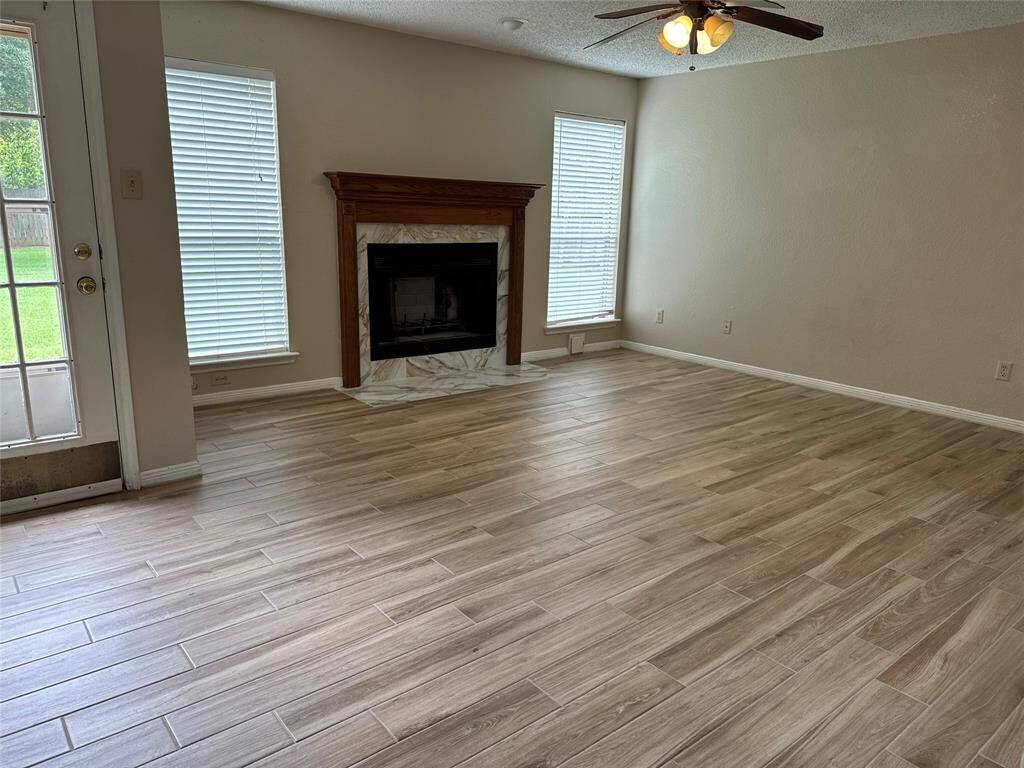 Living area with ample lighting and new floors installed