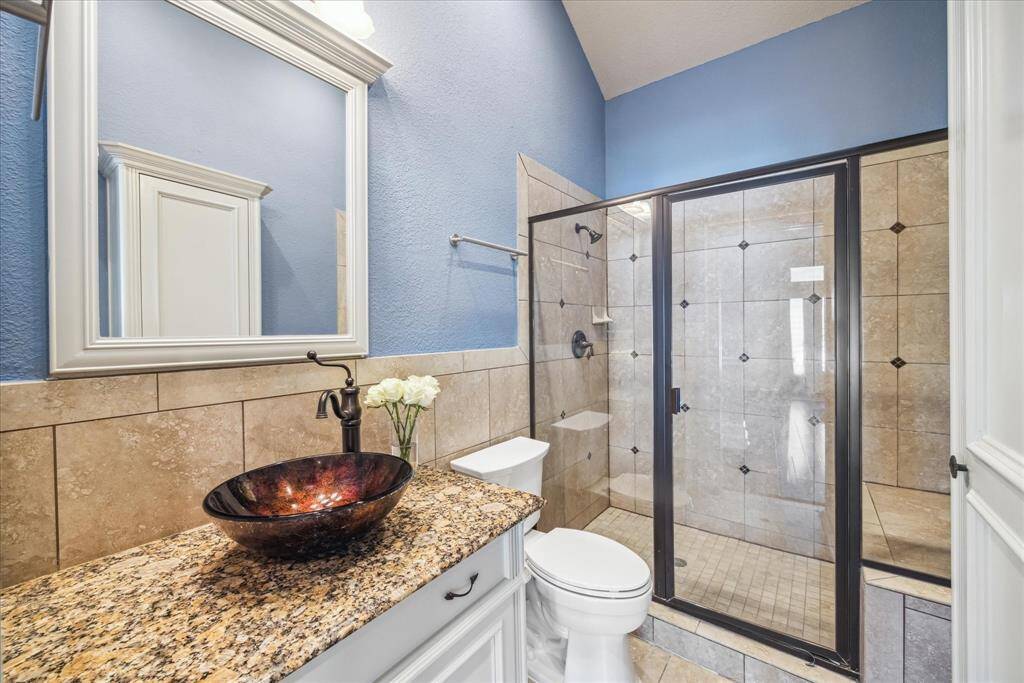 FULL BATHROOM LOCATED ON THE FIRST FLOOR WITH HIGH CEILINGS AND LOTS OF STORAGE.