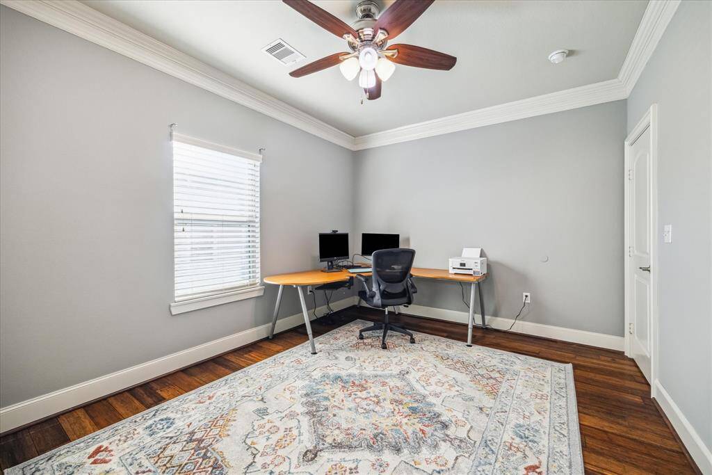 ONE OF THE SECONDARY BEDROOMS, CURRENTLY SET UP AS AN OFFICE.