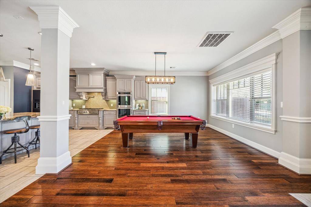 DINING ROOM FEATURES LARGE PORTRAIT WINDOW THAT OVERLOOKS THE FRONT YARD, HARDWOOD FLOORS, AND BUILT-INS FOR CONVENIENT STORAGE.