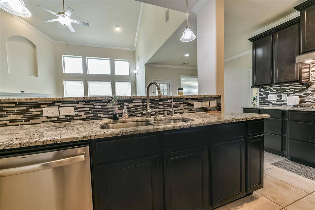The kitchen features dark cabinets,creating a clean and timelessaesthetic.