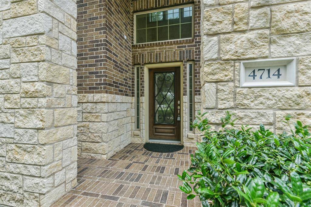 Approaching the front door you will see the beautiful brick and stone elevation, covered front porch, and lovely landscaping.