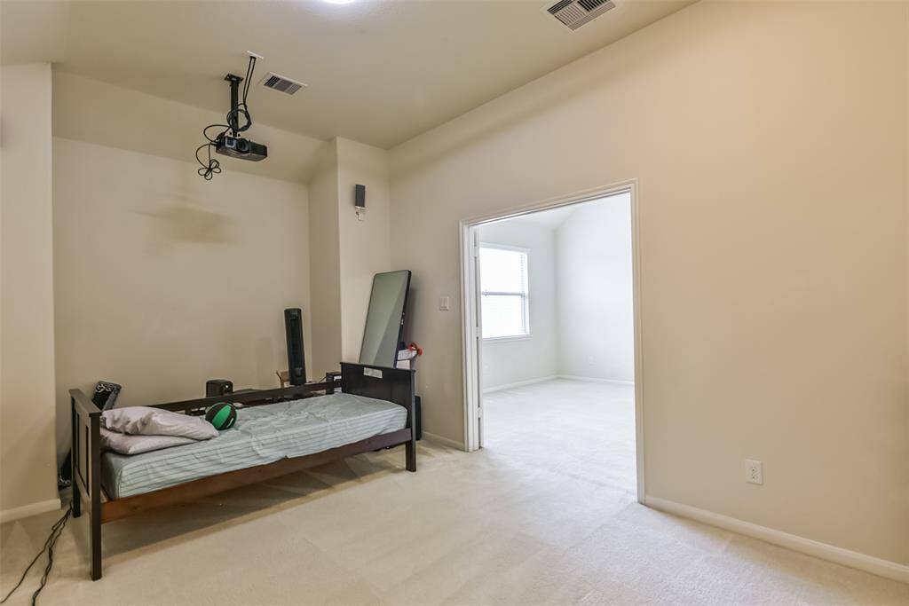 The media room features plush carpet, high ceilings, and recessed lighting.