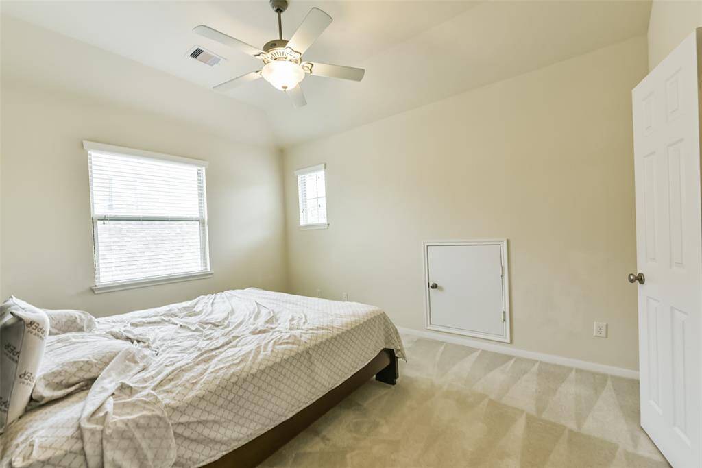 Third bedroom features awindow and plush carpet.