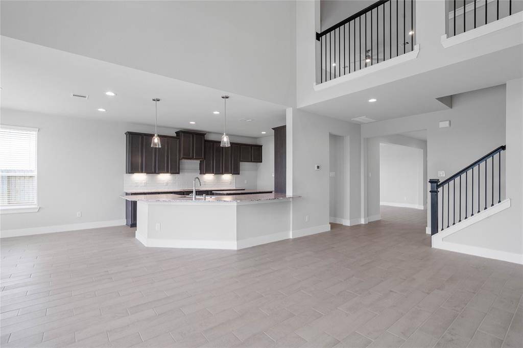 Additional view of this open space living area. This view captures the openness and view of the staircase and second floor.