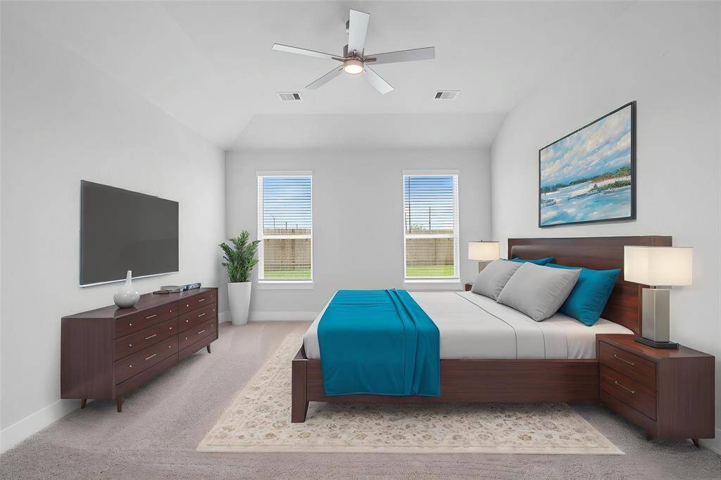 Come and unwind after a long day in this magnificent primary suite! This spacious room features plush carpet, warm paint, high ceilings with ceiling fan, and large windows with privacy blinds.