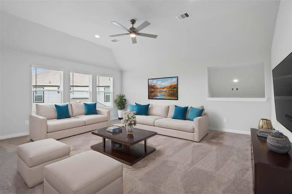 Come upstairs and enjoy a day of leisure in this fabulous game room! This is the perfect hangout spot or adult game room, this space features plush carpet, high ceiling, recessed lighting, ceiling fan, custom paint and large windows with privacy blinds.