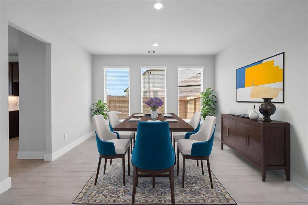 Make memories gathered around the table with your family and friends! This dining room features high ceilings, custom paint, recessed lighting, and large windows with privacy blinds.