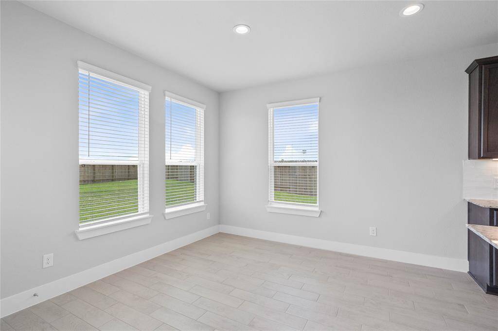 Start your day off right with a cup of coffee sitting with your family in the lovely breakfast area! Featuring large windows with blinds, custom neutral paint, tile flooring, recessed lighting and high ceilings!