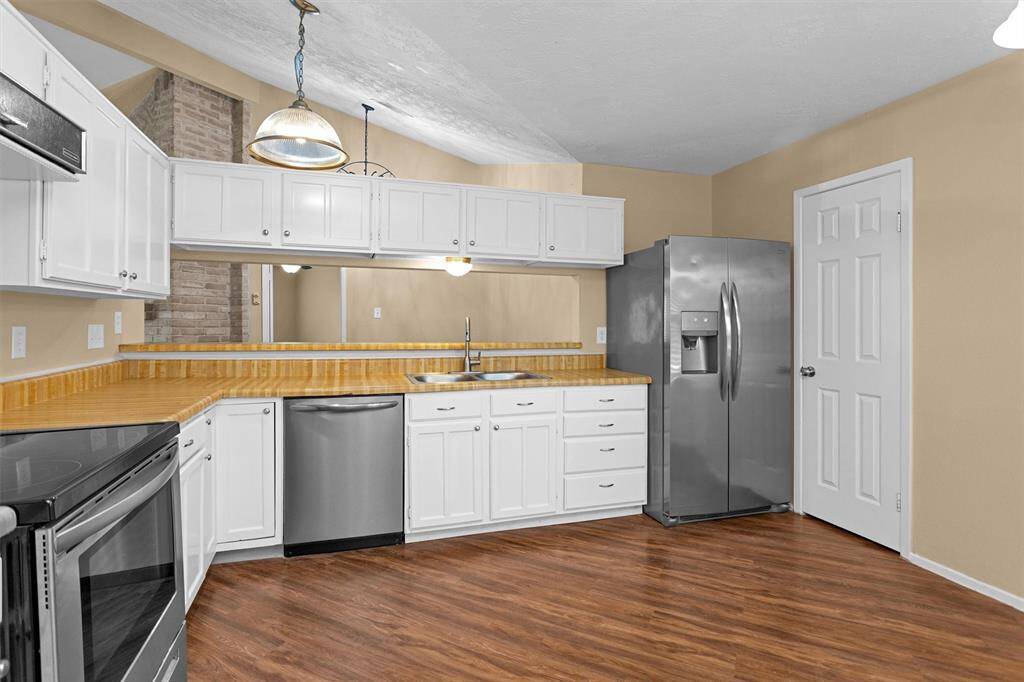 Kitchen has open ceiling and a 9ft bar open to the formal dining
