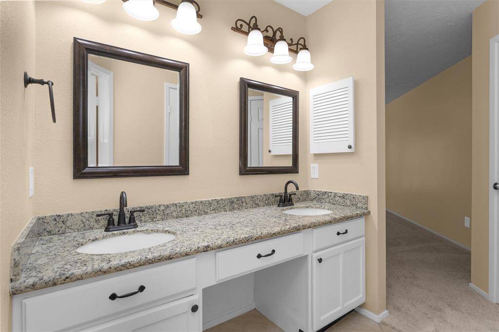Primary bath with granite counter tops.
