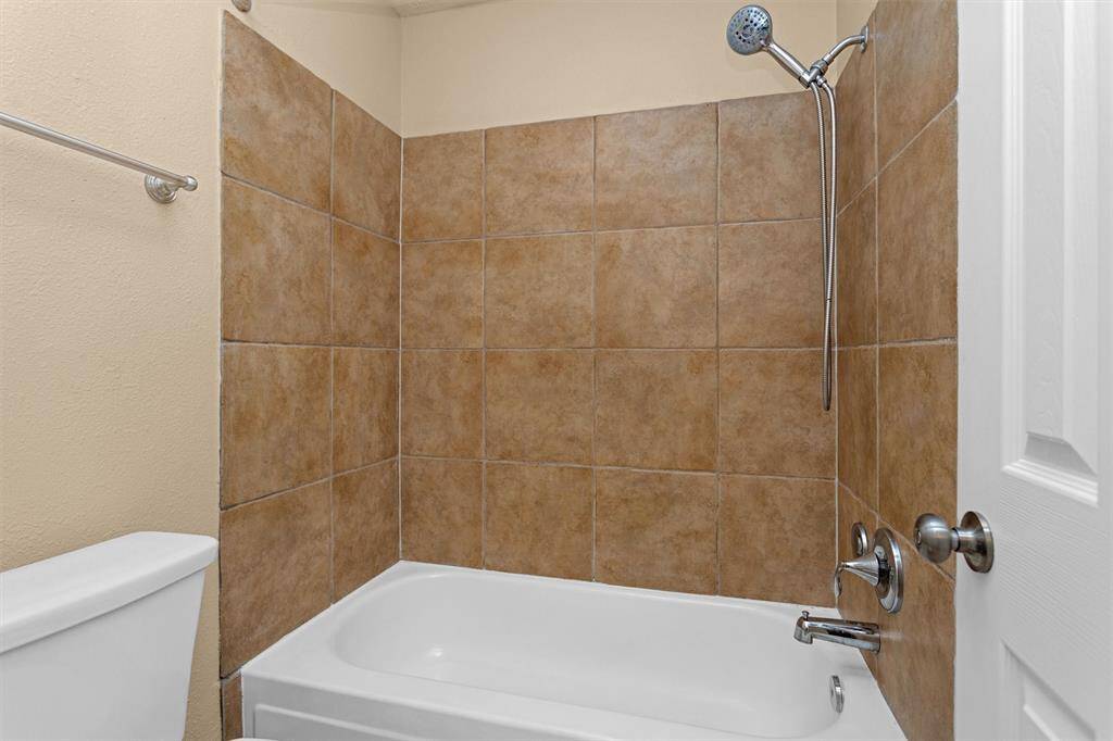 Upgraded tile for tub surround in secondary bathroom.