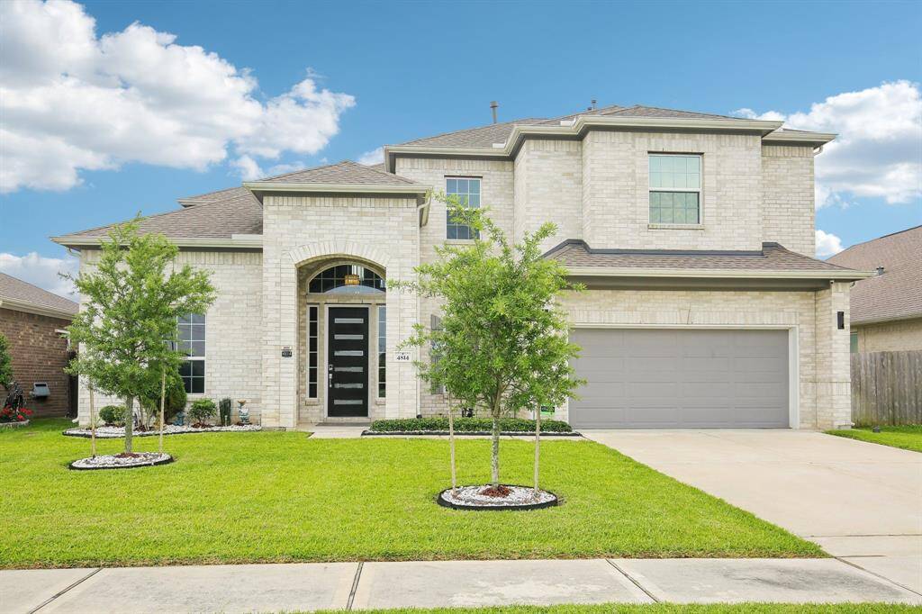 Welcome home to this two-story brick home with modern front door and lovely landscaping!