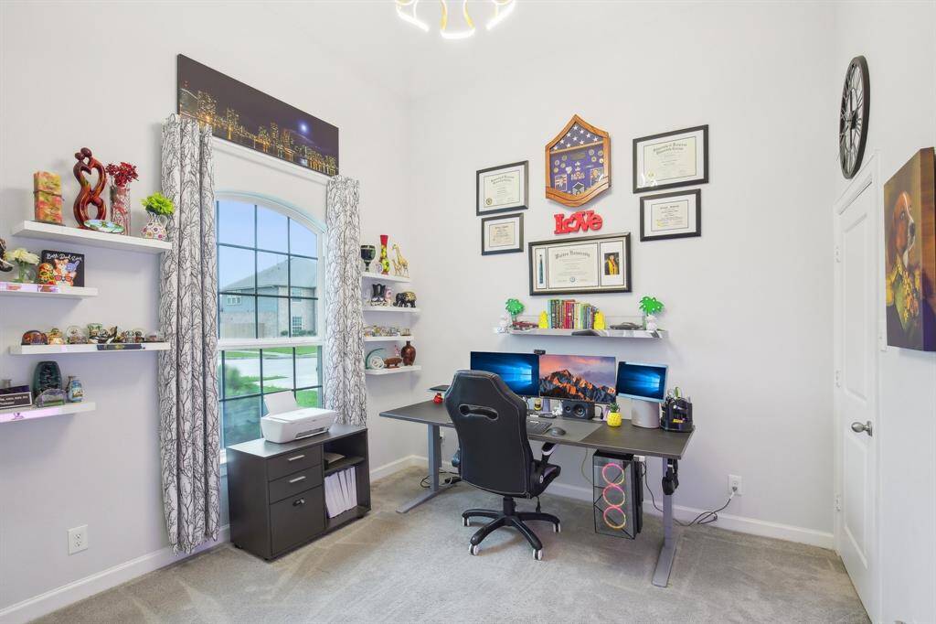 This home office features a neutral color palette and a spacious walk-in closet - could be a possible 5th bedroom!