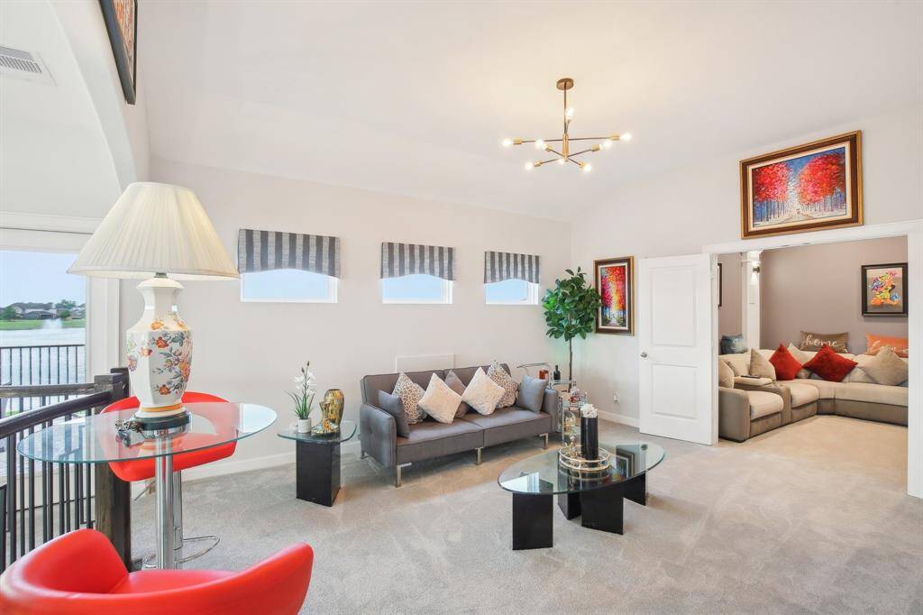 This bright, inviting game room is ideal for relaxation and entertainment. The room connects to a cozy media room through double doors.