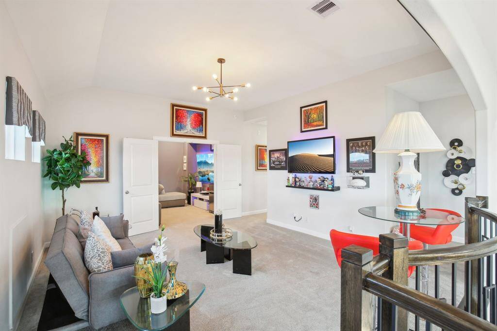 This bright, inviting game room is ideal for relaxation and entertainment. The room connects to a cozy media room through double doors.