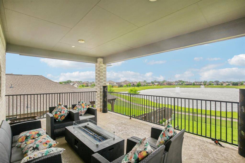 Your private balcony is perfect for comfortable seating, offering stunning views of a serene lake with fountains. Perfect for relaxing or entertaining.