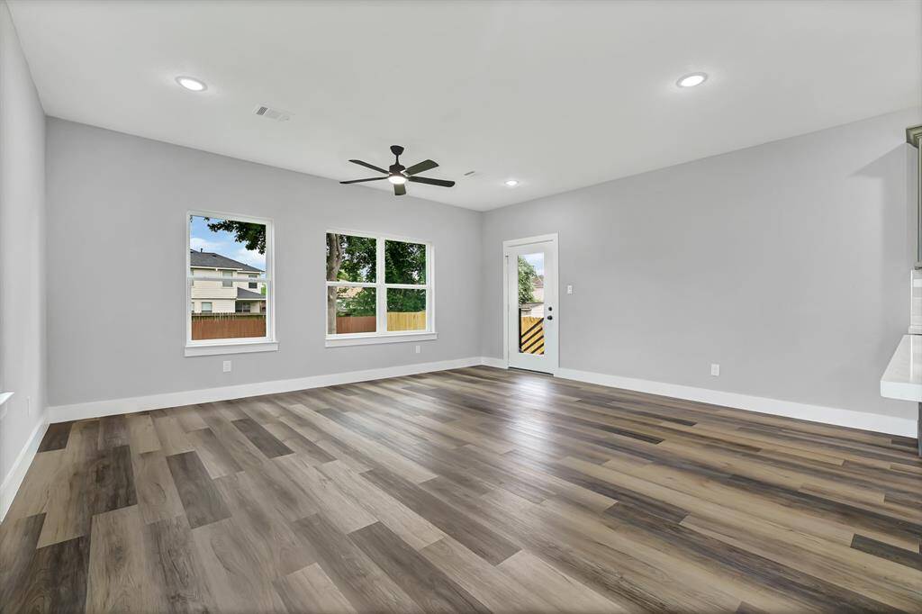 spacious living room has access to the rear covered porch