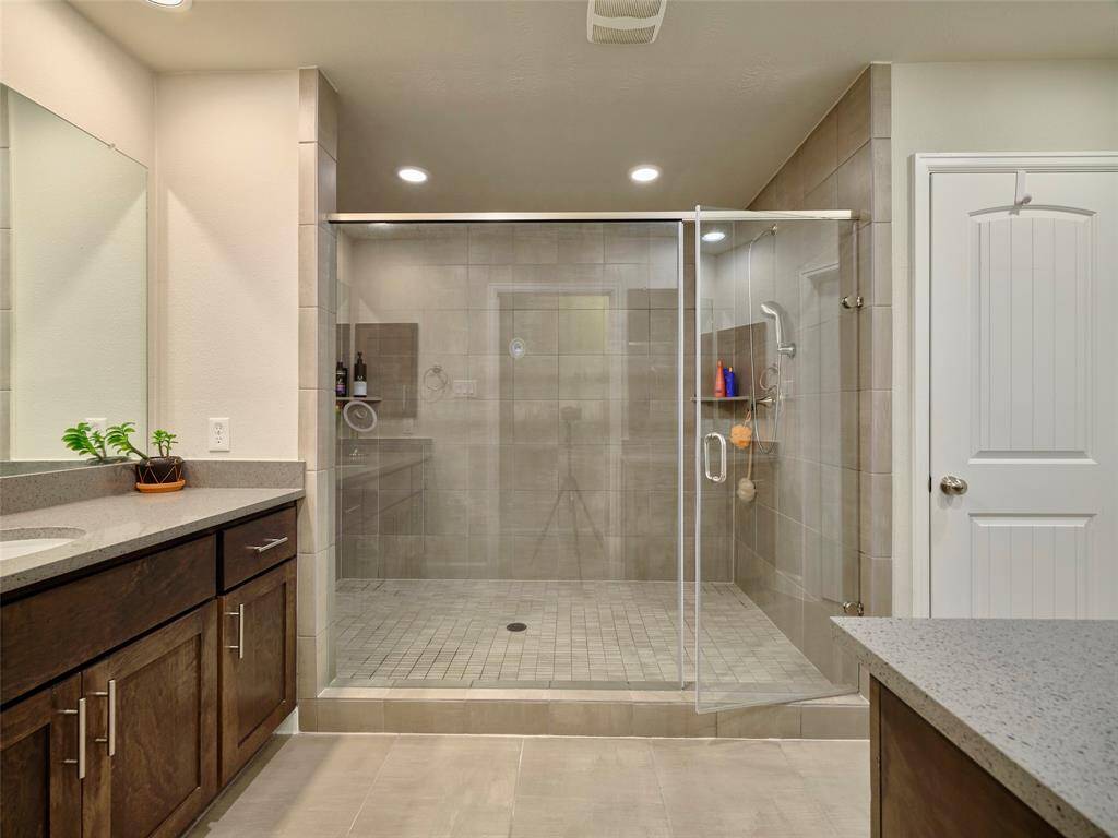 The primary bathroom includes an expansive shower and two spacious vanities.