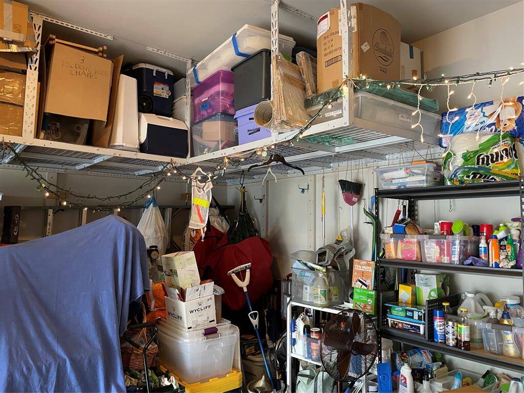 Garage has ceiling mounted storage racks