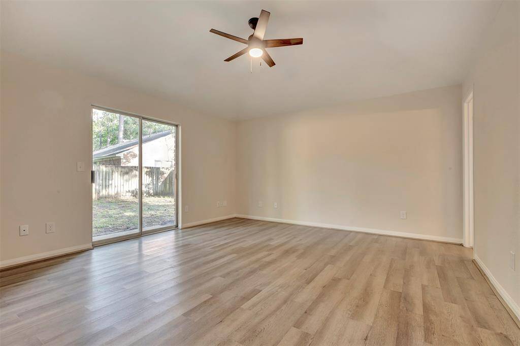Primary bedroom featuring sliding patio doors with a view of the backyard.