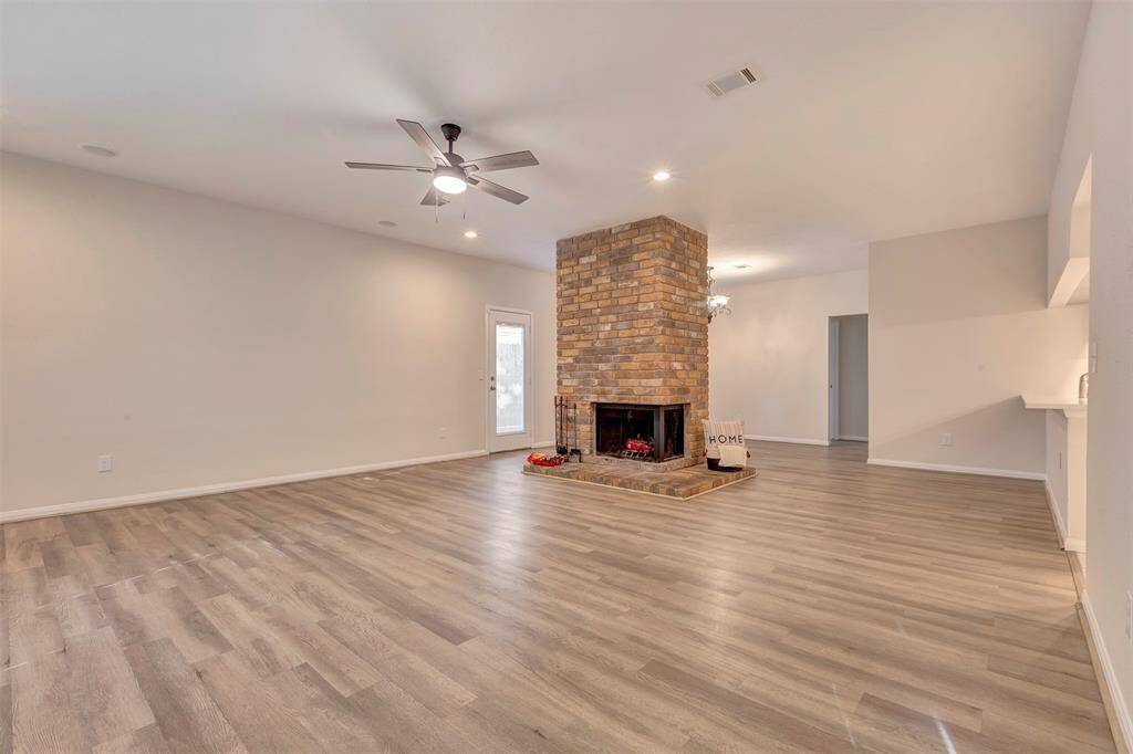 Living area featuring a cozy fireplace, perfectly situated between the formal Dining room and main living space.