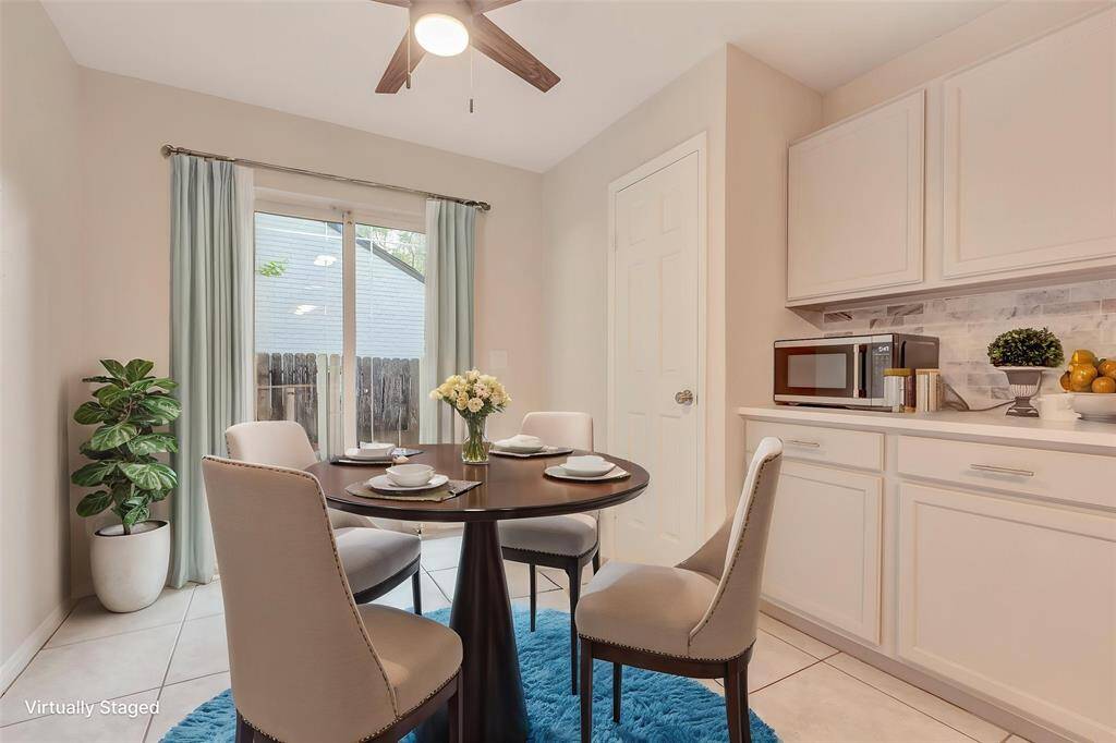 Virtually staged Cozy breakfast area with sliding patio doors offering a view to the outdoor space.