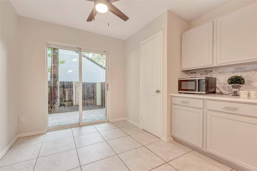 Cozy breakfast area with sliding patio doors offering a view to the outdoor space.