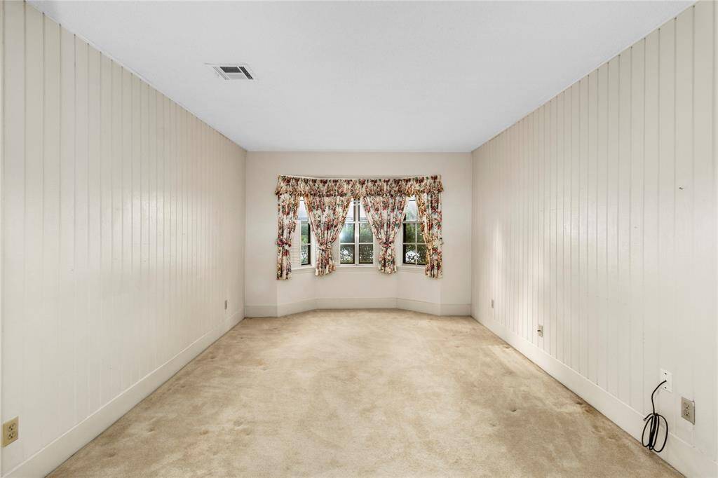 Extra Room next to Entry Hall & Owner's Suite! Could be used as a Study, Extra Bedroom, Game Room...YOU DECIDE! Bay Window w/View of Lushly Landscaped Front Yard!