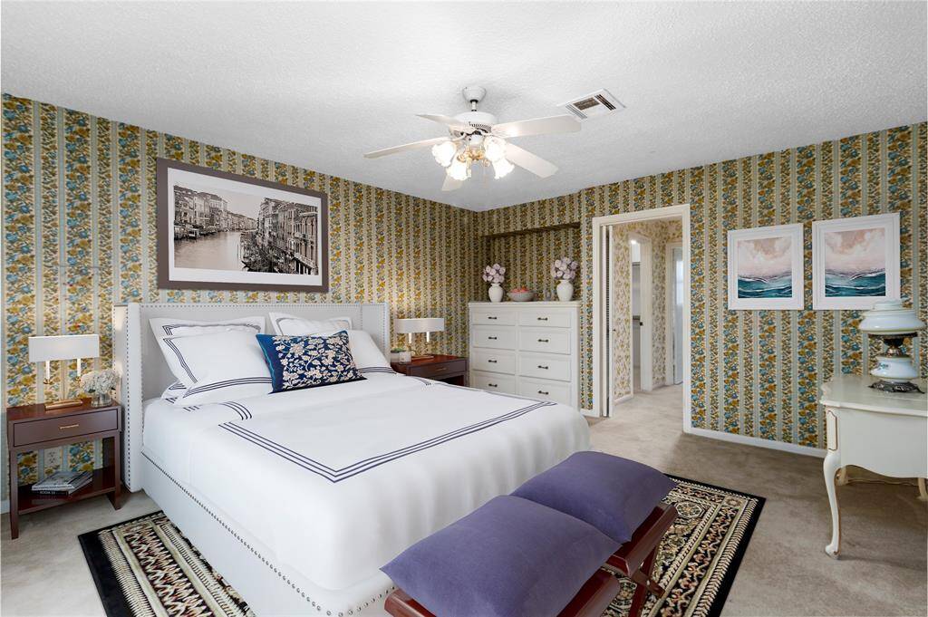 VIRTUALLY STAGED PHOTO! SPACIOUS & PRIVATE Owner's Suite! Plenty of Room for King Bed & Sitting Area! Built-in Dresser! Connects to Spa-like Ensuite Bath!