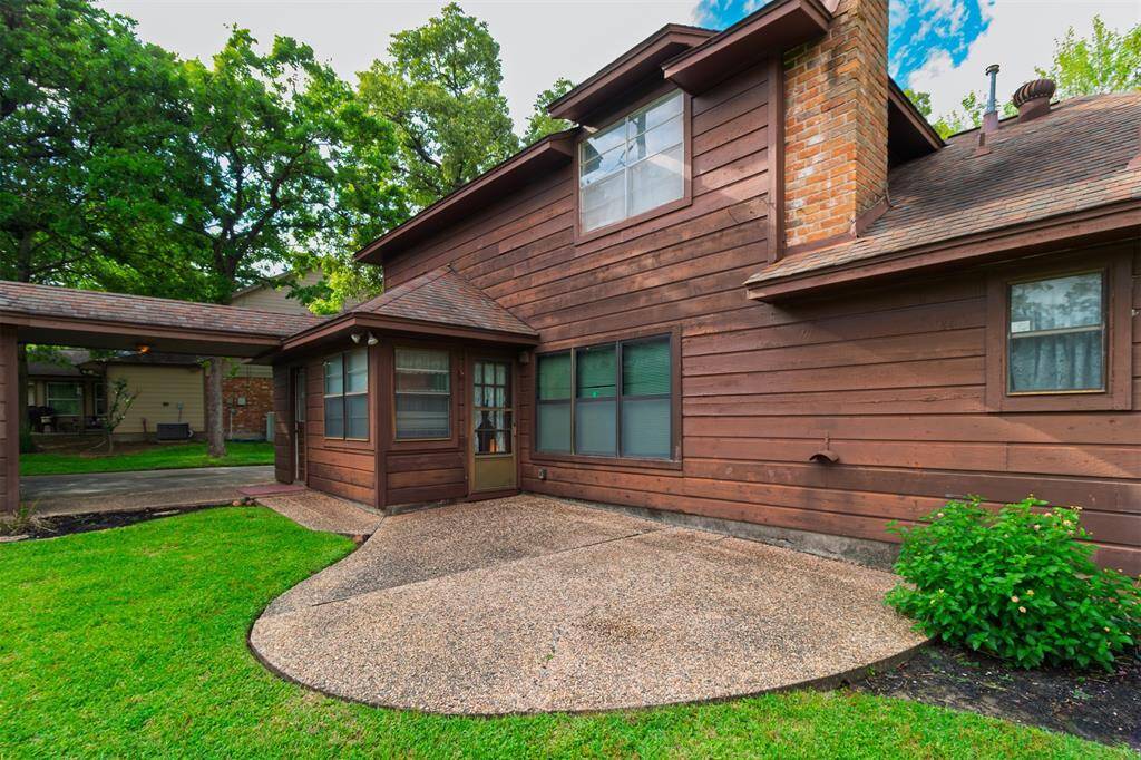 Back of Home w/Patio for Outdoor Living! View of Covered Walkway from Laundry Room to the Detached Garage! French Door Entry to Breakfast Room!