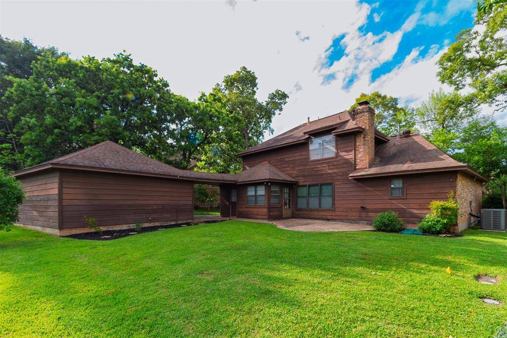 BACKYARD OASIS! Back of Home w/Patio for Outdoor Living! View of Covered Walkway from Laundry Room to the Detached Garage! French Door Entry to Breakfast Room!