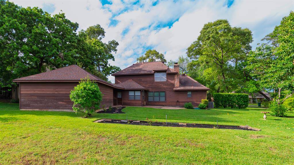 BACKYARD OASIS! Back of Home w/Patio for Outdoor Living! View of Covered Walkway from Laundry Room to the Detached Garage! French Door Entry to Breakfast Room!