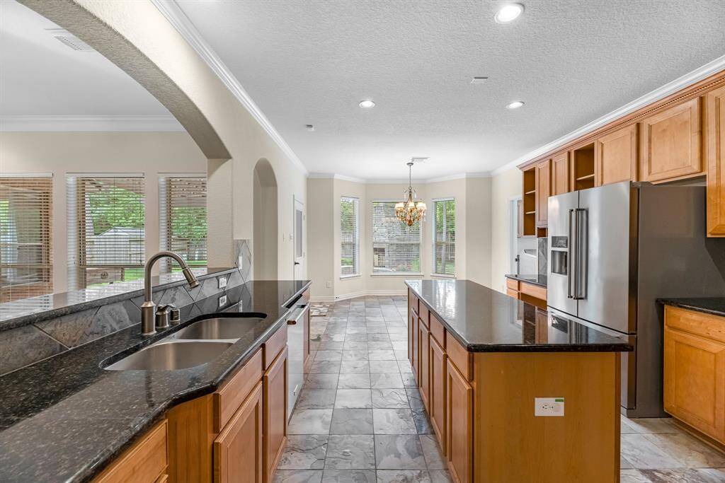 Spacious kitchen with island and stainless steel appliances
