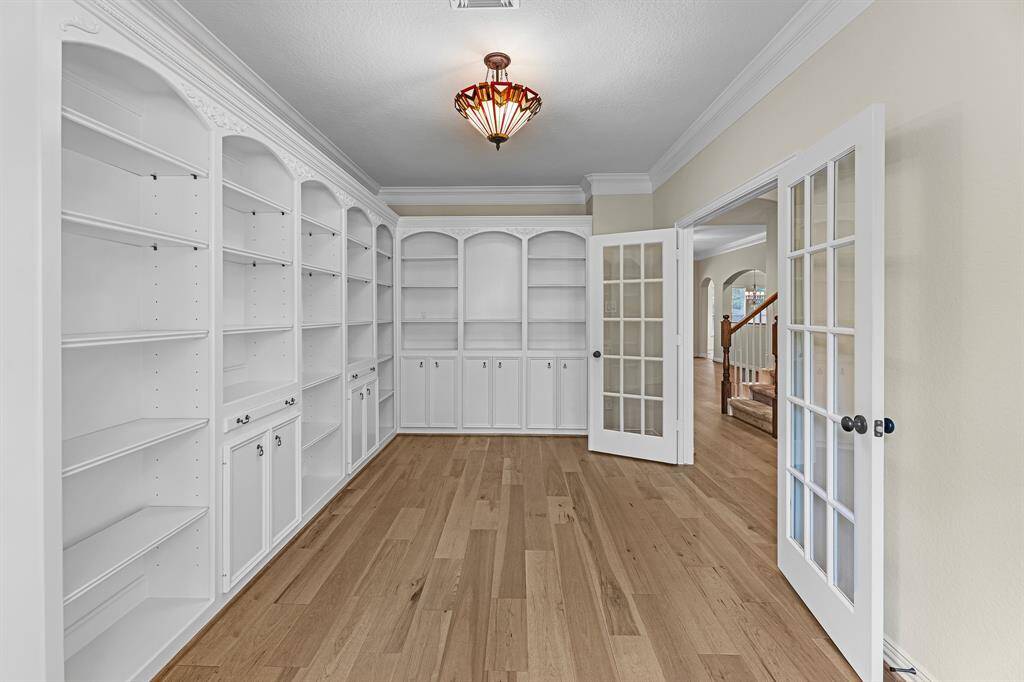 Home office with built-ins, french doors to offer privacy while working from home