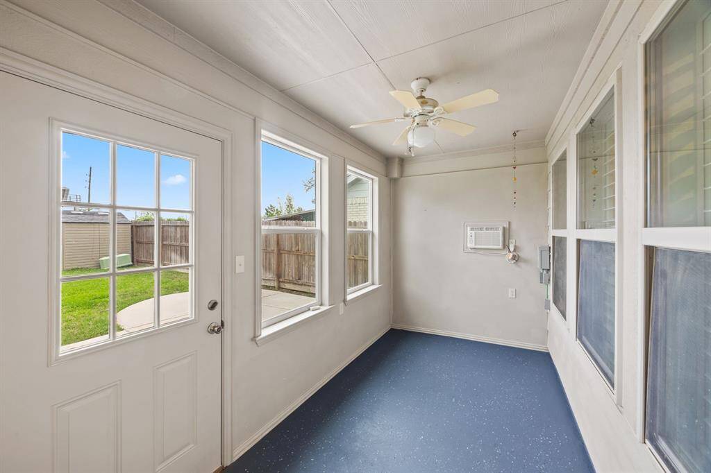 Sun room with separate AC, ceiling fan and painted concrete floor. Use this room to your needs and imagination; mud room, kids play room, arts & crafts, painting, plants, etc.