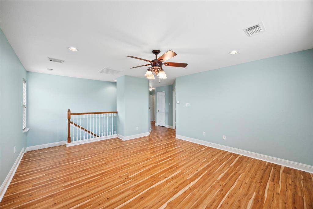 View toward the stairs and hall to bedrooms of the Gameroom. Look at the beautiful flooring that would complement just about anything you bring into the roo.