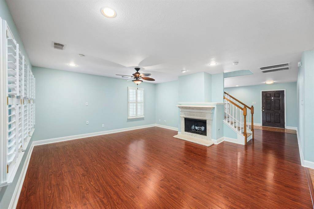 View towards front door of the living room and fireplace.