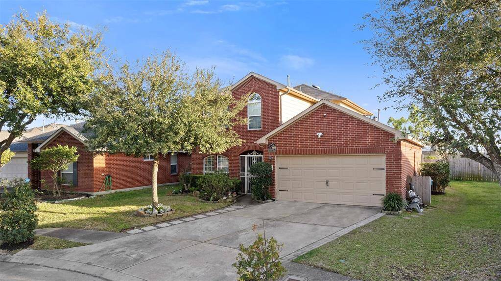 Charming two-story brick home with a two-car garage, well-maintained front yard, and mature trees. Features a welcoming driveway and a spacious, fenced backyard. Ideal for family living in a serene neighborhood.