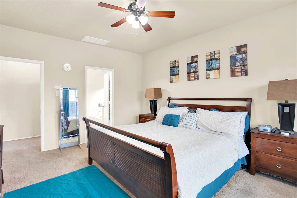 Discover serene comfort in this bright and airy bedroom, complete with a cooling ceiling fan, plush carpeting, and soothing neutral tones. Delight in the convenience of a private en suite bathroom.