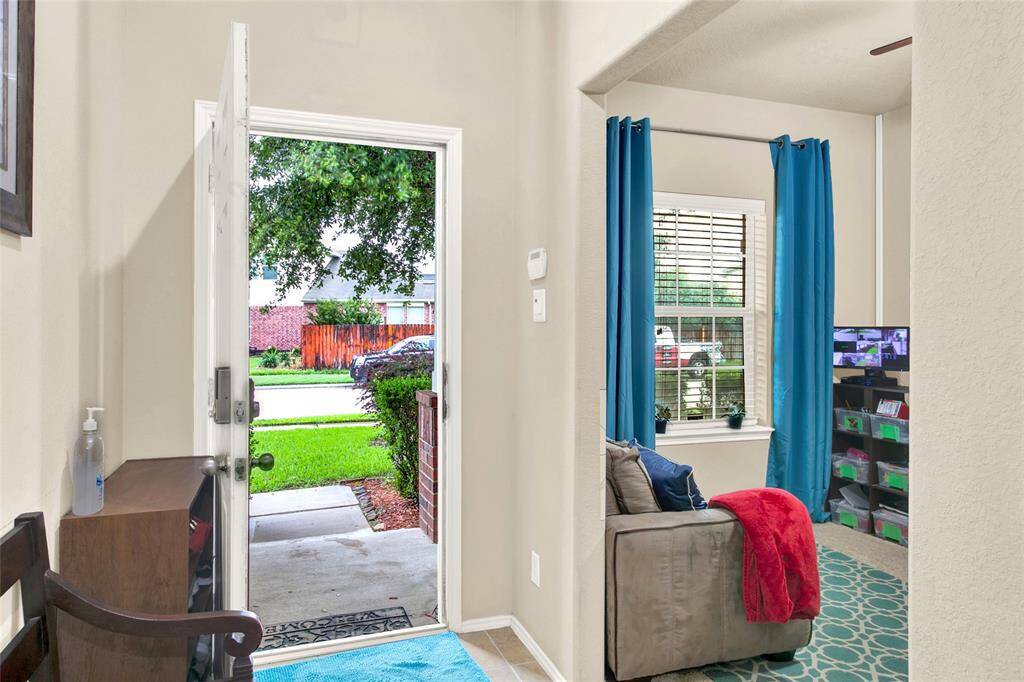 Step into comfort in this inviting, sun-lit space that immediately feels like home.