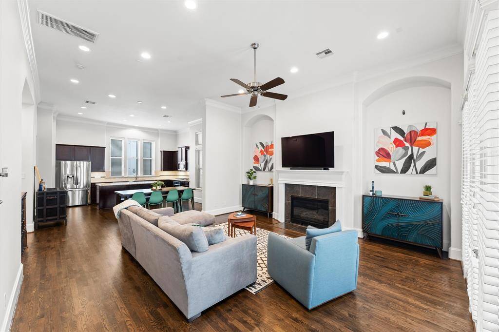 Cozy fireplace and custom wall insets add warmth and character to the spacious living room.