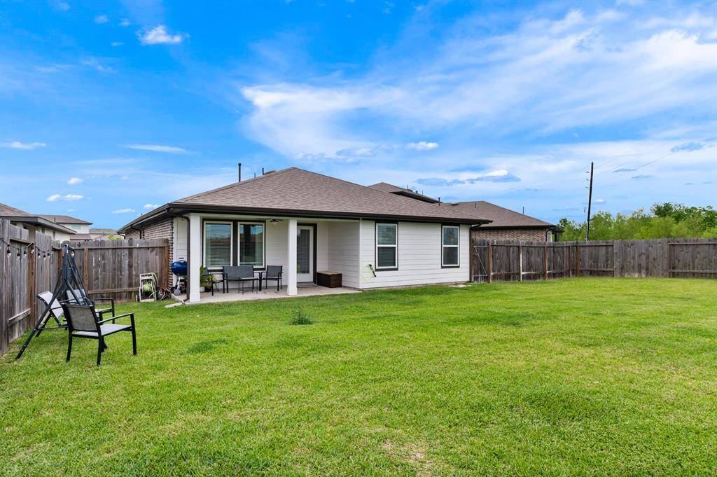 The oversized backyard offers plenty of space for outdoor activities and entertaining. A large covered patio provides the perfect spot for relaxing in the shade or hosting gatherings year-round.