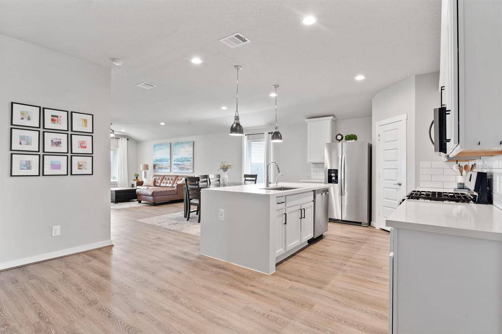 a spacious open-concept kitchen, dining, and family room designed for seamless living and entertaining.