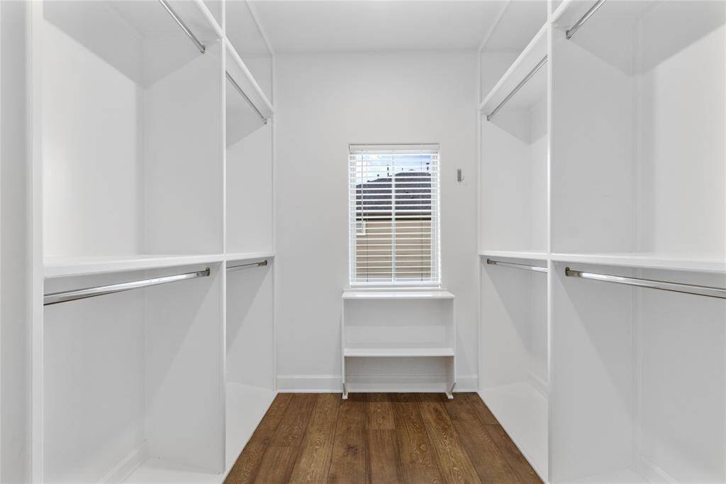 Expansive walk-in closet with ample hanging space.