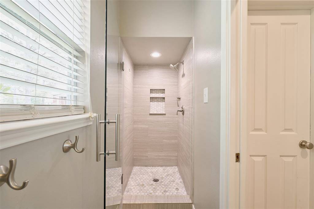 Enjoy the view of the pool from this bedroom currently being used as an office.