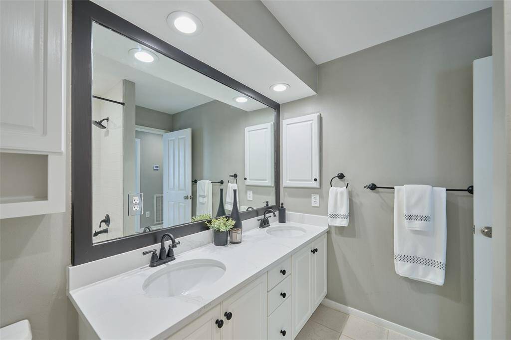 The shower/tub combo has new black Moen fixtures.